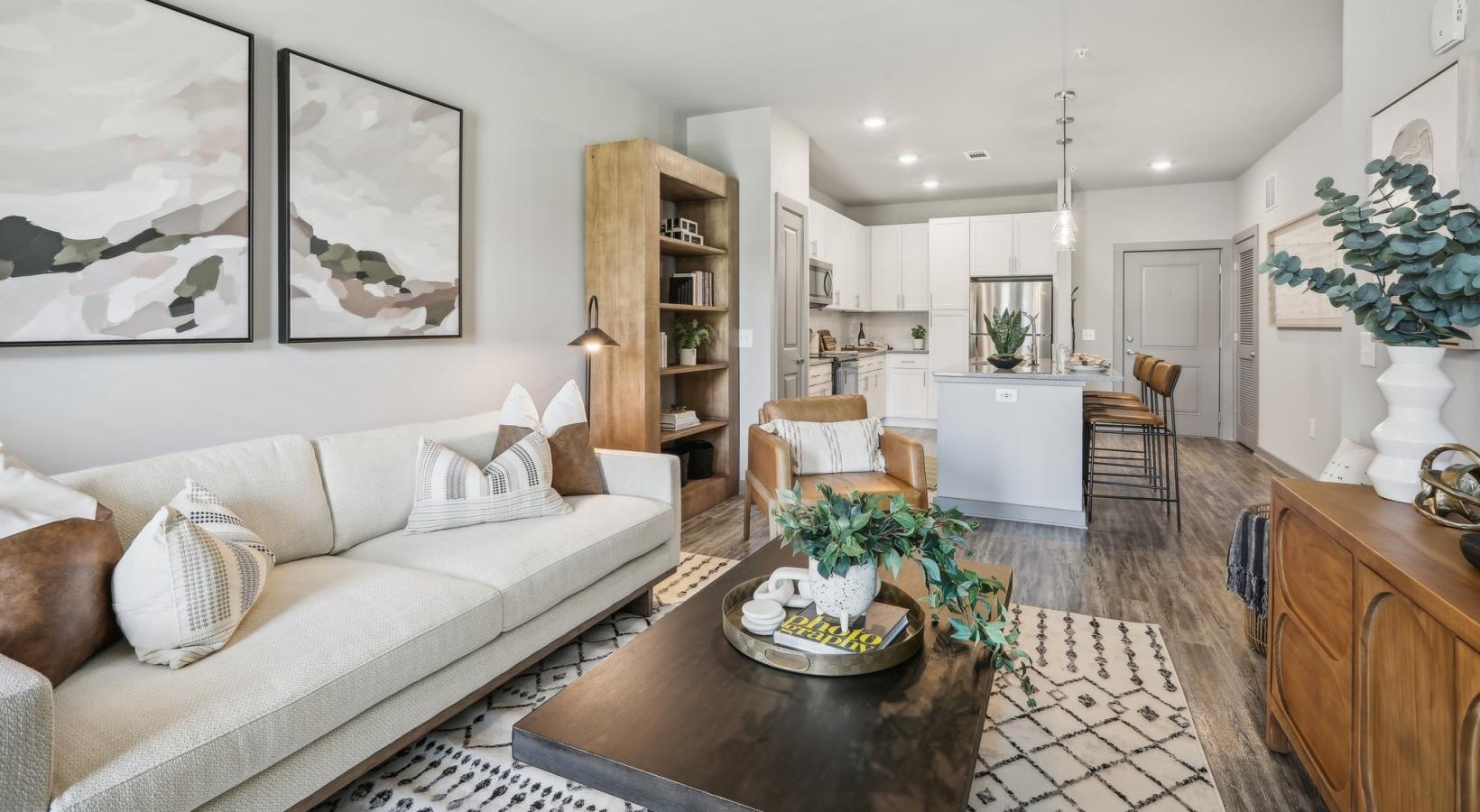 Settle into comfort at Accent Suwanee Creek a living room with a couch and a table