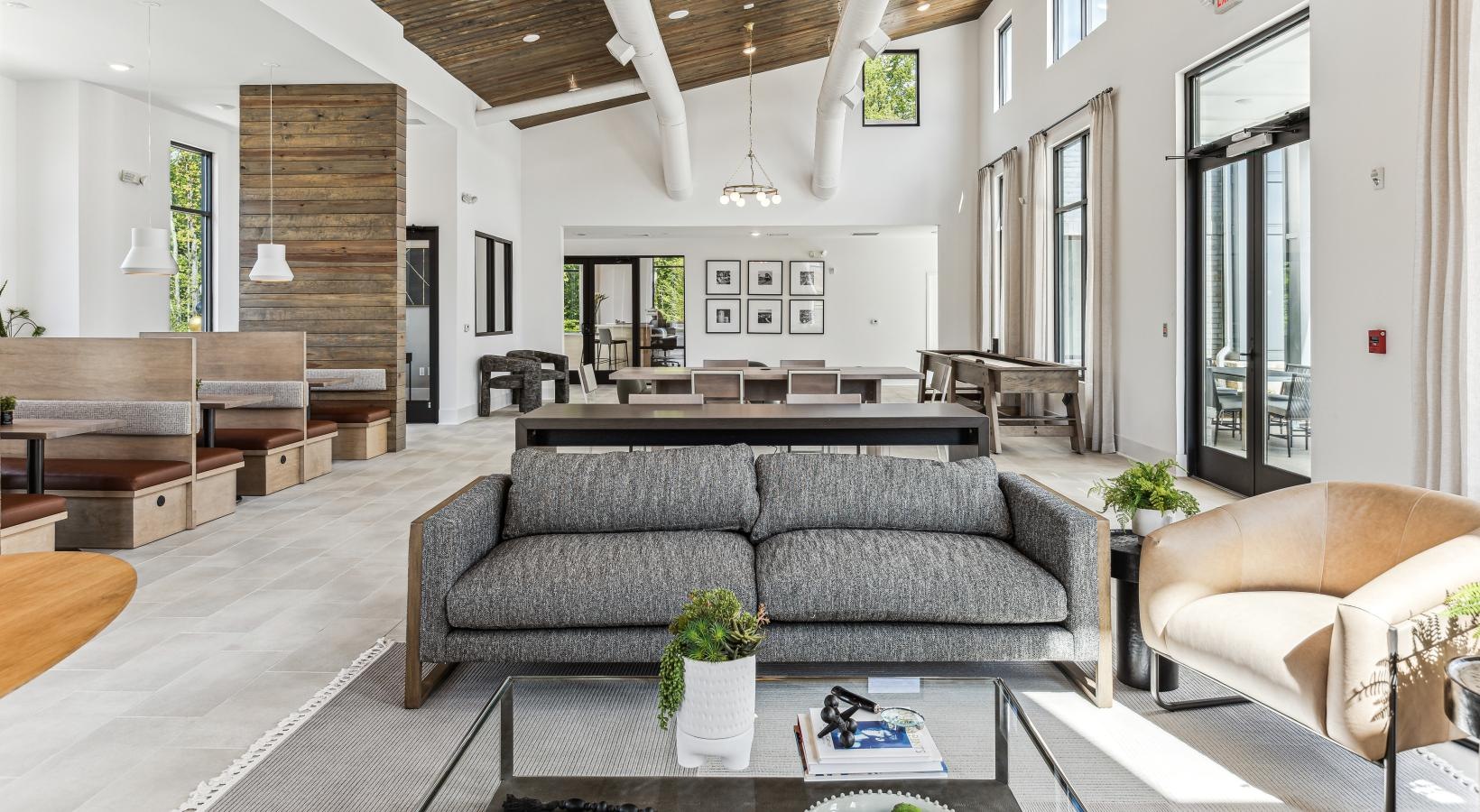 Find your perfect fit at Accent Suwanee Creek a large living room with a large couch and a table