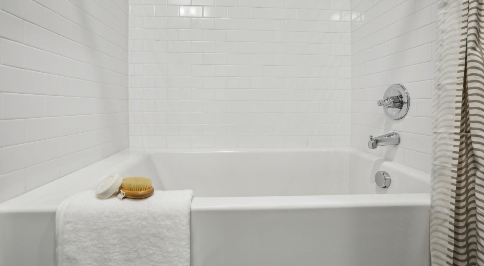 Spacious bathrooms with everything you need a bathtub with a towel on the side