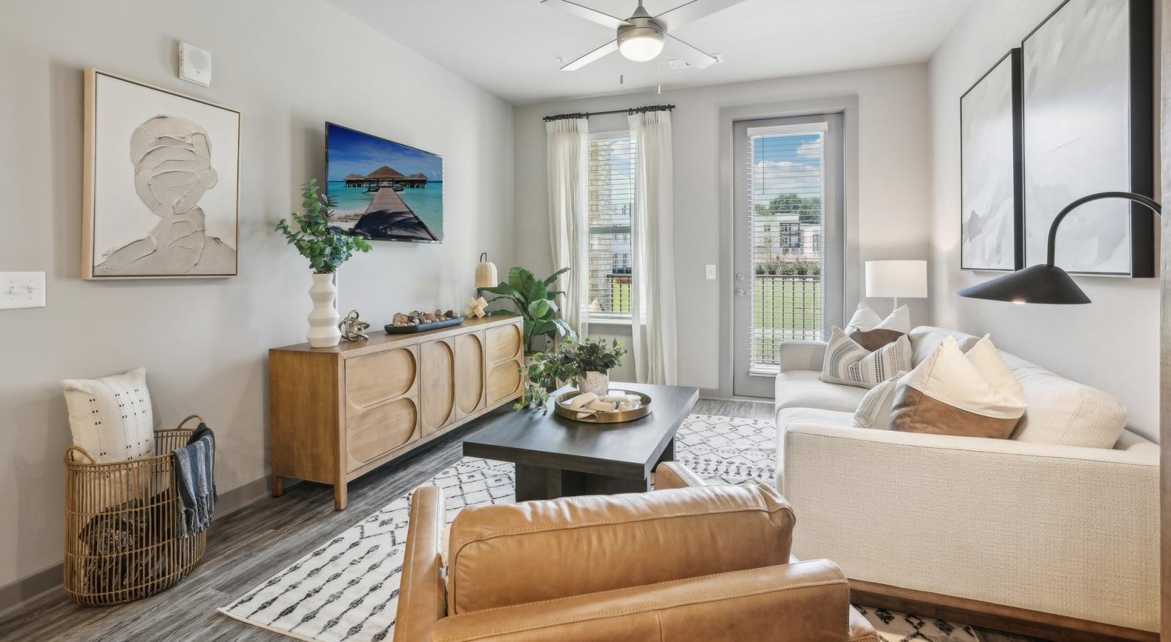 Find your perfect fit at Accent Suwanee Creek a living room with a large chandelier and a couch