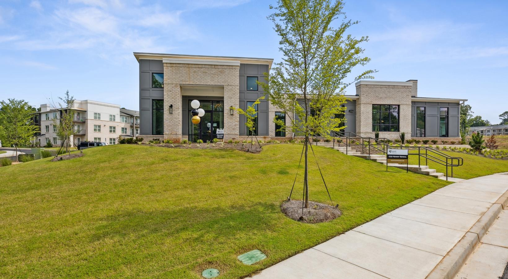 Settle into comfort at Accent Suwanee Creek a building with a tree in front