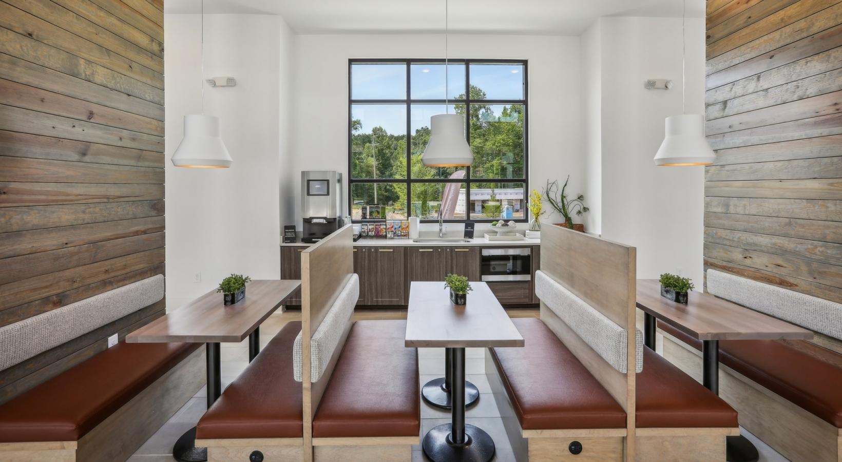 Enjoy our resident-only features a room with a table chairs and a window